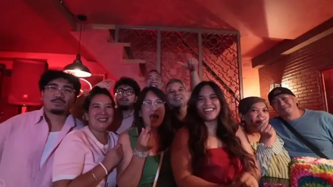 Friends crowding together for a group photo at a 30th birthday party