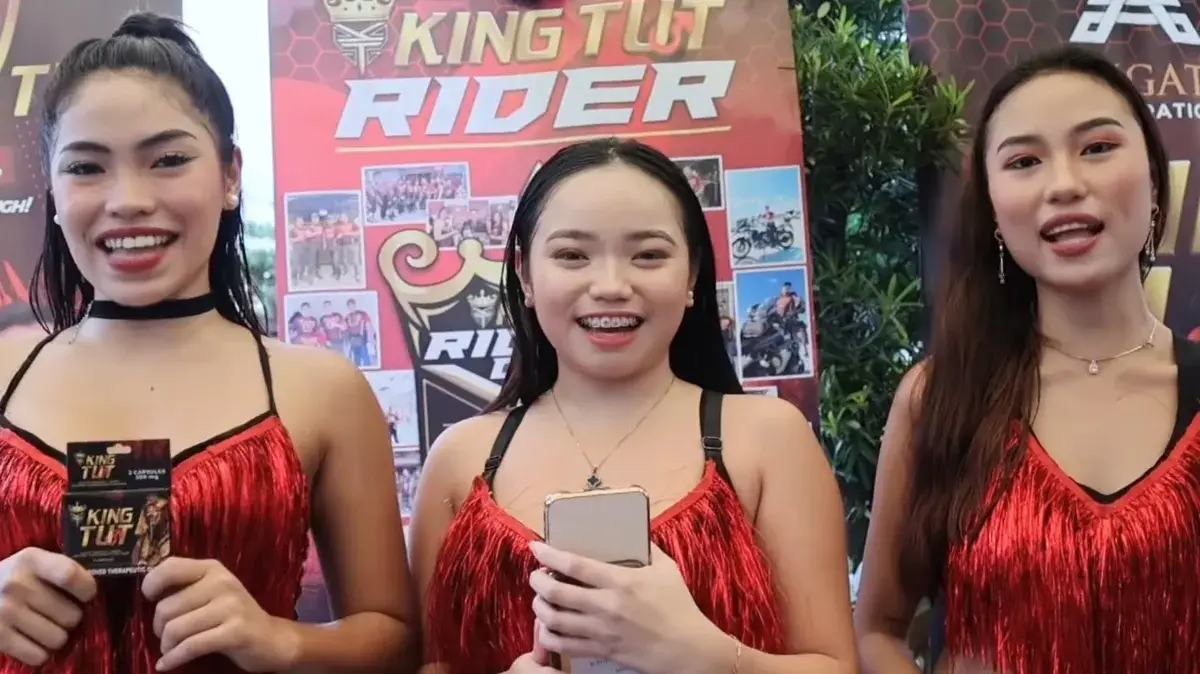 Three brand ambassadors in red fringe dresses presenting products at a brand event