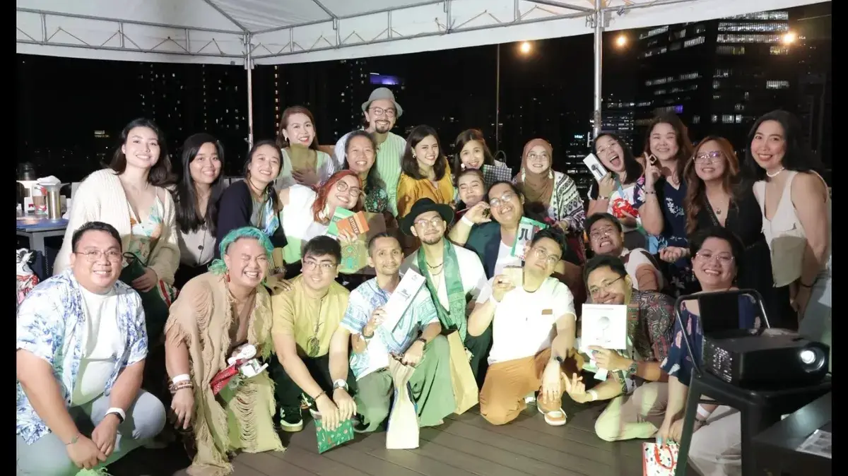 Large group photo of employees under a tent at a company Christmas party